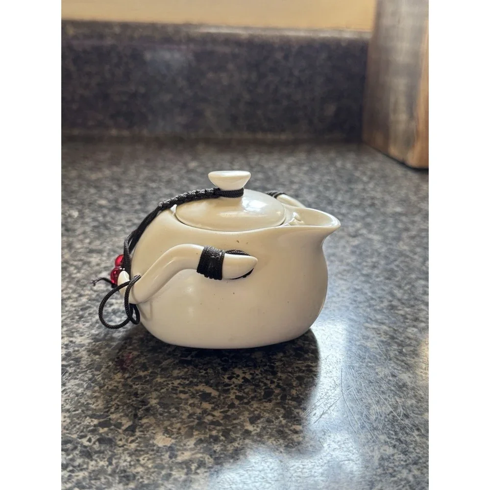 Compact travel tea pot white ceramic with decorative cord